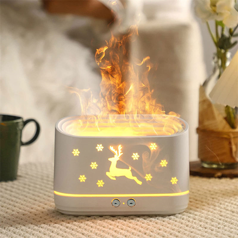 Difusor Llama encendido sobre una mesa con manta y taza