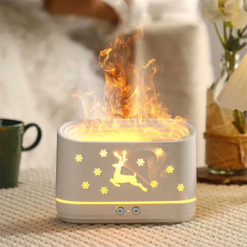 Difusor Llama encendido sobre una mesa con manta y taza